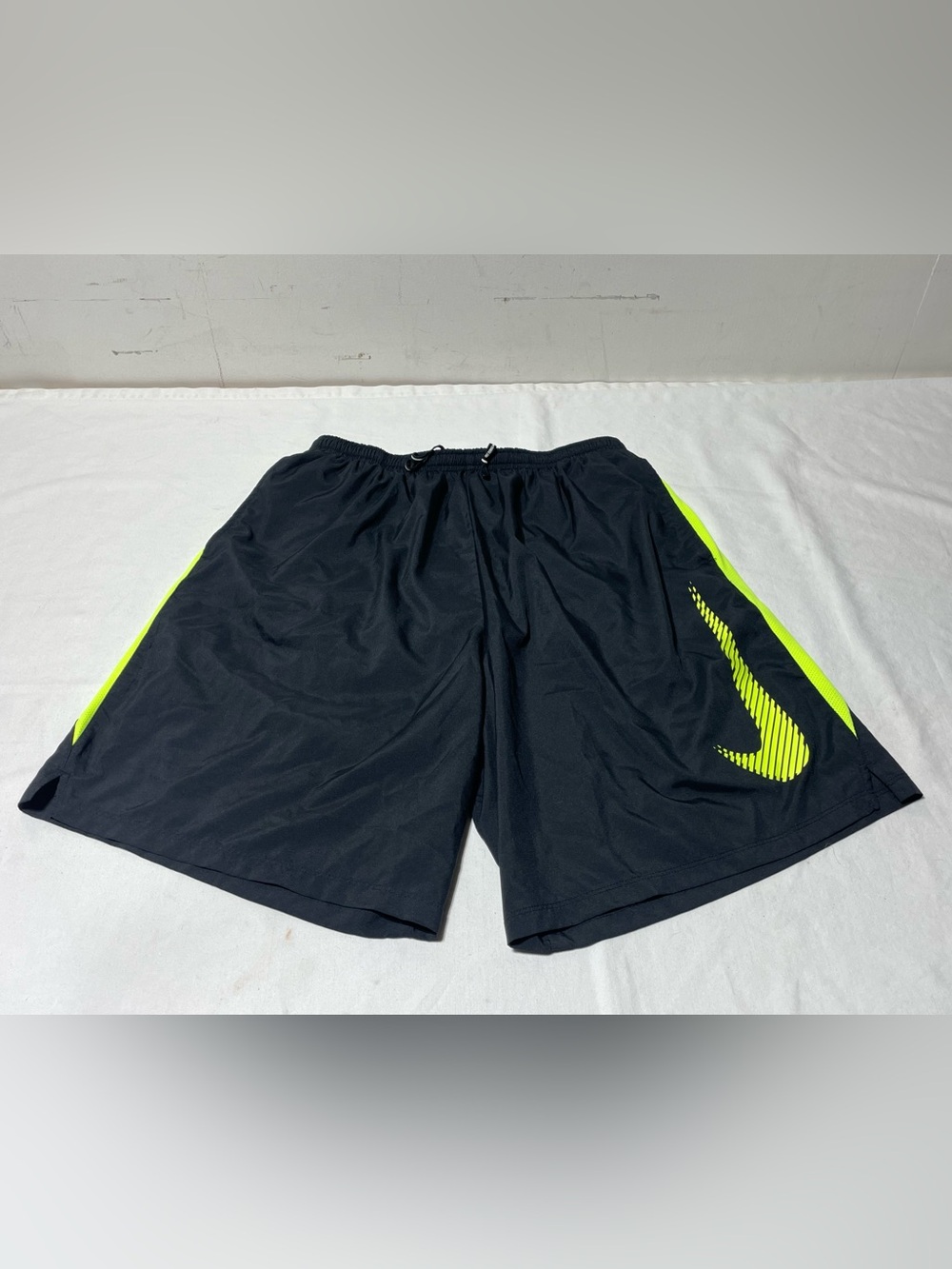 Nike Men's Black Athletic Shorts with Neon Yellow Swoosh